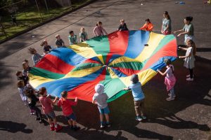 School children undertaking a team-building activity on the basketball court