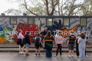 Students on camp at StayKCC in front of the mural wall