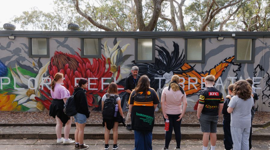 Students on camp at StayKCC in front of the mural wall