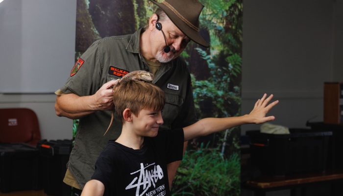 Walkabout Reptiles presenting their reptile show to a group of students.