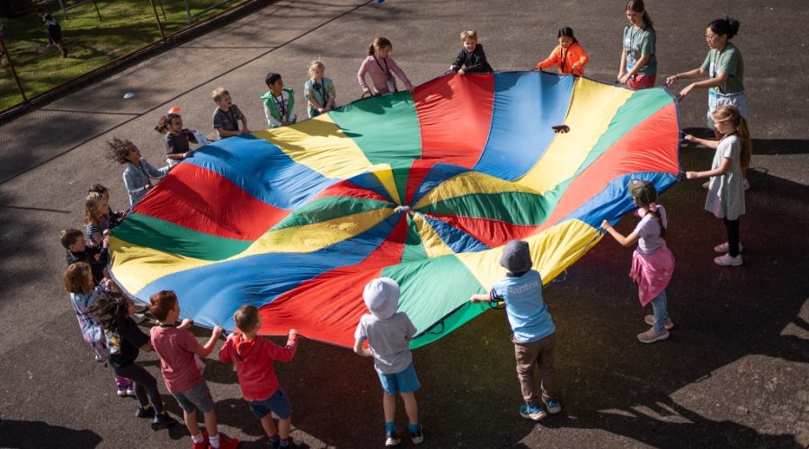 School children undertaking a team-building activity on the basketball court